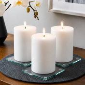 A clean and intentional product display featuring clear glass Square Coaster 4" candle bases - thumbnail number 10