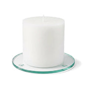 An unlit white pillar candle on a clear glass Round Coaster 4" against a white backdrop - thumbnail number 2