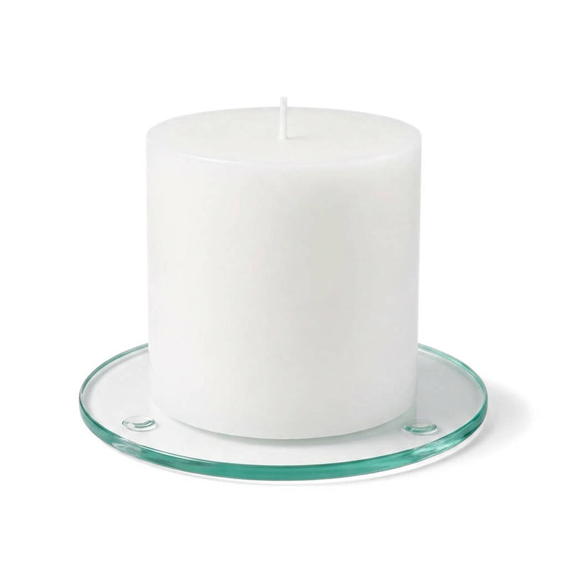 An unlit white pillar candle on a clear glass Round Coaster 4" against a white backdrop - thumbnail number 2