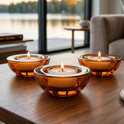 Three amber glass tealight holders on a wooden table with a scenic lake view through a window - thumbnail number 7