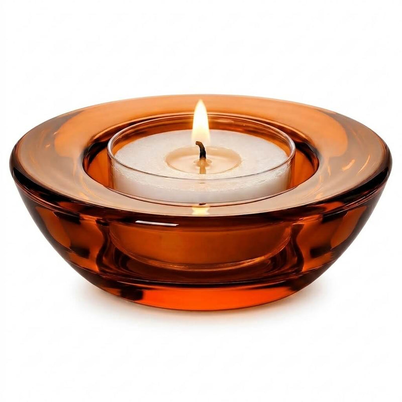 Lit white tealight candle inside a round amber glass holder isolated on a white background - thumbnail number 3