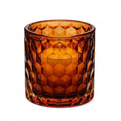 Amber honeycomb glass votive and tealight holder with white candle on white background - thumbnail number 4