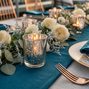 Silver glass candle holders with white roses on an elegant blue table setting - thumbnail number 5