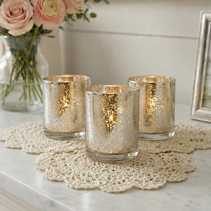 Set of glowing mercury glass candle holders on a lace mat with soft floral decor - thumbnail number 6