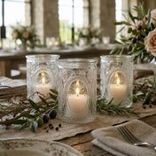 Three glass candle holders with glowing candles on rustic olive-themed dining table - thumbnail number 4