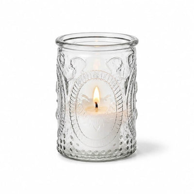 Textured clear glass candle holder with a lit white candle inside - thumbnail number 3