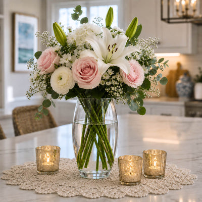 10" clear vase with pink roses and white lilies on a doily - thumbnail number 9