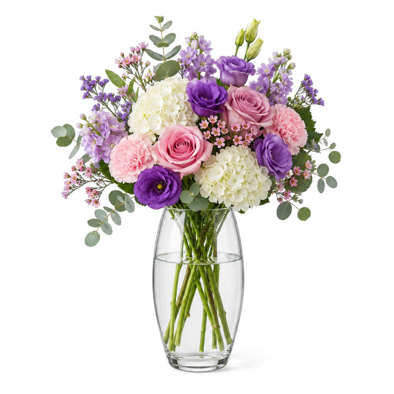 10" clear vase holding a bouquet of purple, pink, and white flowers - thumbnail number 3