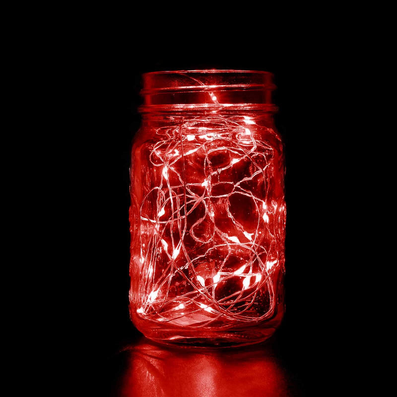 Red fairy lights in a mason jar against a black background.  - thumbnail number 1