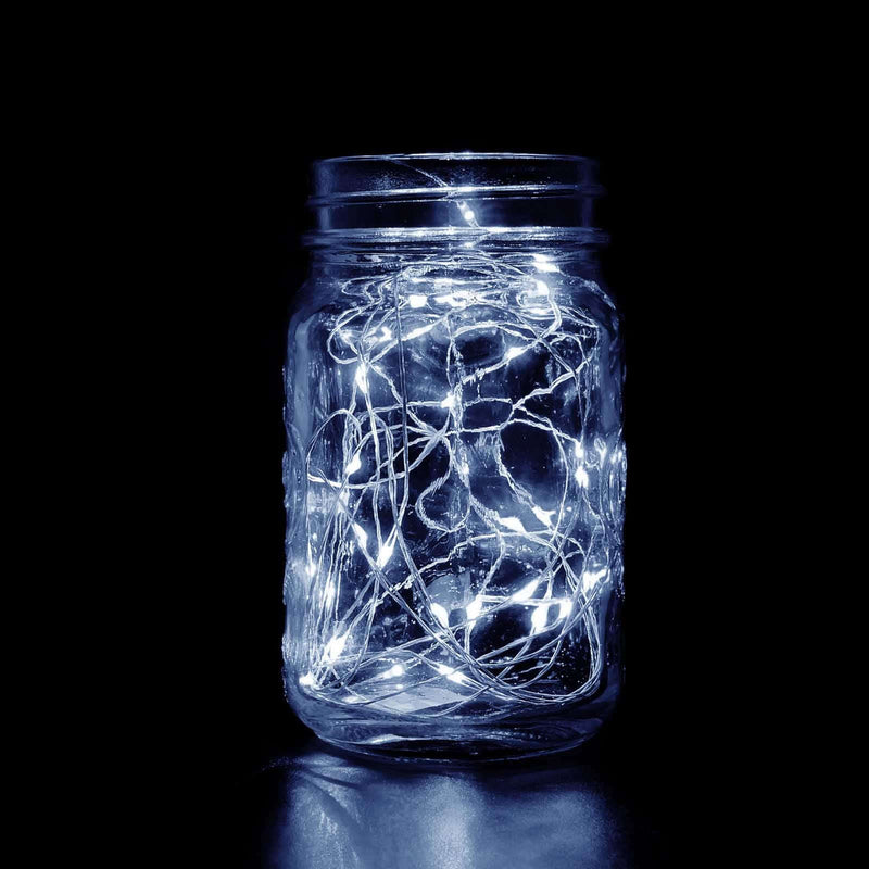 LED fairy lights in a glass jar against a dark background.  - thumbnail number 1