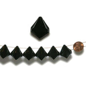 Black crystal pyramid beads on a string with a penny for scale.  - thumbnail number 1