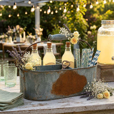 Weathered metal gray caddy holding drinks, straws, and flowers at a party - thumbnail number 3