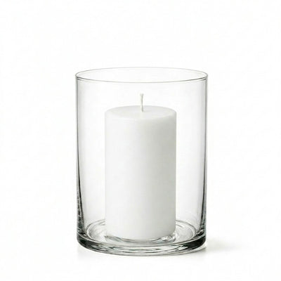 An unlit white pillar candle centered inside a clear glass Wide Cylinder Vase on white - thumbnail number 2