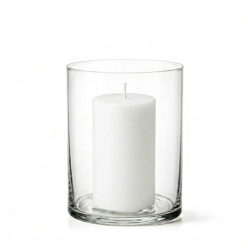 An unlit white pillar candle centered inside a clear glass Wide Cylinder Vase on white - thumbnail number 2