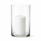 An unlit white pillar candle inside a clear glass cylinder vase on a white background - thumbnail number 2