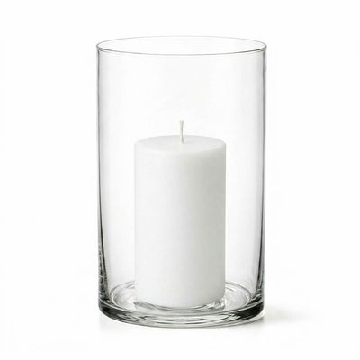An unlit white pillar candle inside a clear glass cylinder vase on a white background - thumbnail number 2