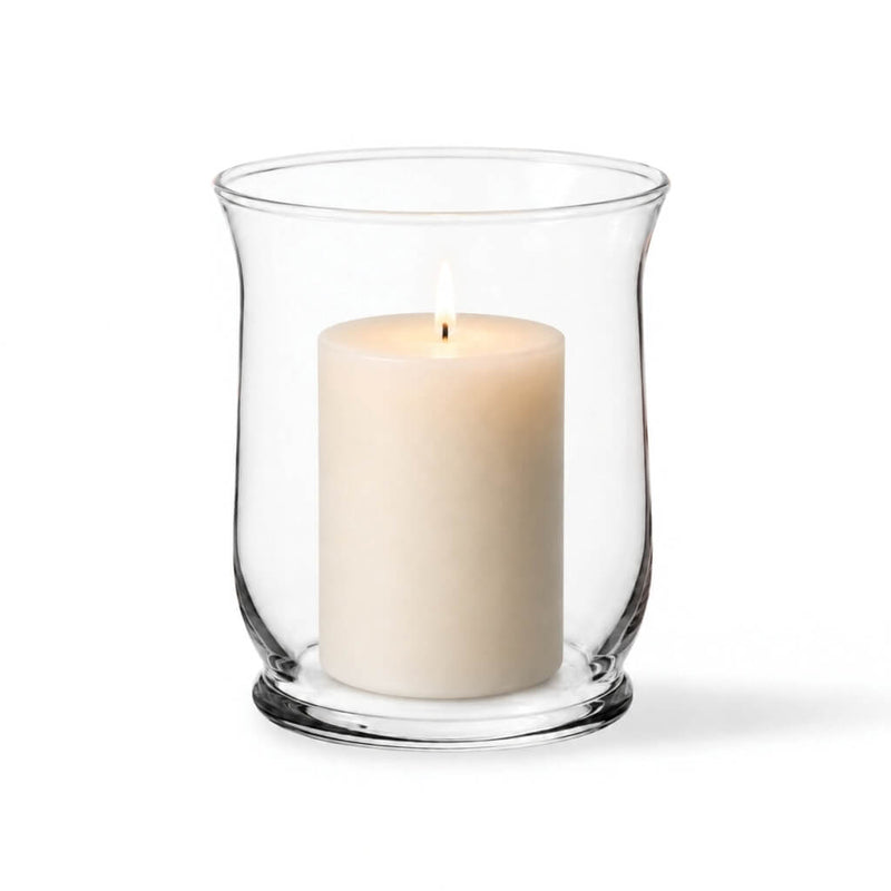 Warm candle flame glowing from within a classic clear glass 6" Hurricane Vase on white - thumbnail number 3