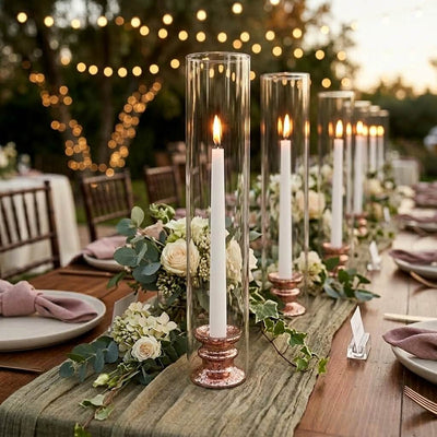 Glass Chimney Candle Shade 2.5" x 12" tubes on lit taper candles lining an elegant outdoor table - thumbnail number 6
