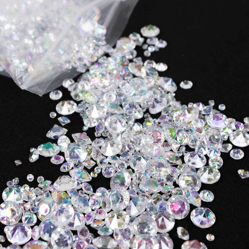 Mixed clear rhinestones scattered on a black surface. - thumbnail number 1