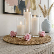 Pink preserved roses and pillar candles in glass holders on a woven placemat - thumbnail number 7