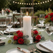 Red preserved roses surround a candle in a glass cylinder - thumbnail number 3