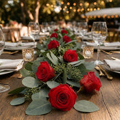 Red preserved roses and eucalyptus leaves form a table runner - thumbnail number 6