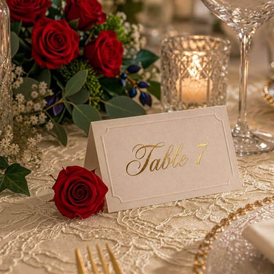 A red preserved rose sits next to a Table 7 place card on a festive table - thumbnail number 7