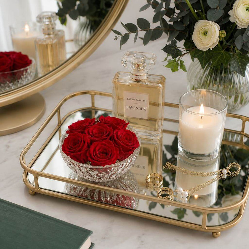 Red preserved roses in a bowl on a mirrored tray with perfume and a candle - thumbnail number 8
