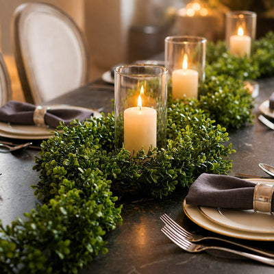 9ft faux boxwood garland used as a dining table centerpiece with pillar candles - thumbnail number 3