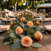 Peach preserved roses and eucalyptus leaves form a table runner - thumbnail number 2