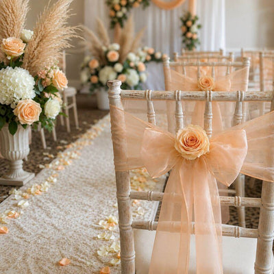 White chairs adorned with peach sashes and peach preserved roses for a wedding aisle - thumbnail number 5
