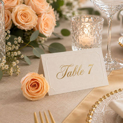 A peach preserved rose sits next to a Table 7 place card on a festive table - thumbnail number 6