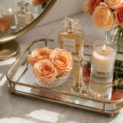 Peach preserved roses in a bowl on a mirrored tray with perfume and a candle - thumbnail number 8