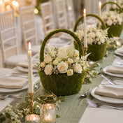 Moss basket filled with white roses and candles on table - thumbnail number 4