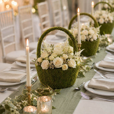 Moss basket filled with white roses and candles on table - thumbnail number 4