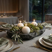 Three lit white sphere candles nestled in a stone bowl with green moss and olive branches - thumbnail number 4