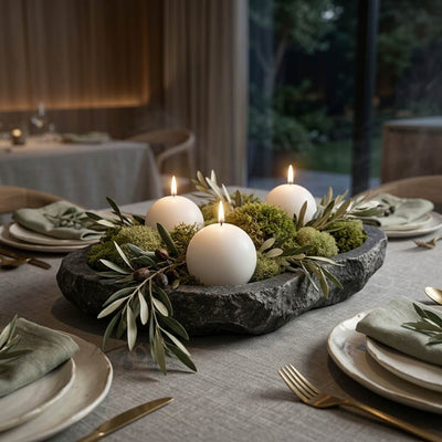 Three lit white sphere candles nestled in a stone bowl with green moss and olive branches - thumbnail number 4
