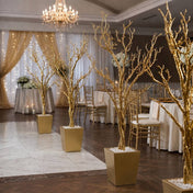 Row of potted gold faux manzanita trees lining a venue floor - thumbnail number 2