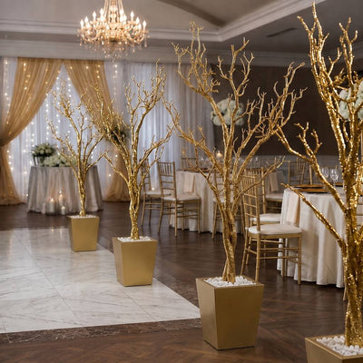 Row of potted gold faux manzanita trees lining a venue floor - thumbnail number 2
