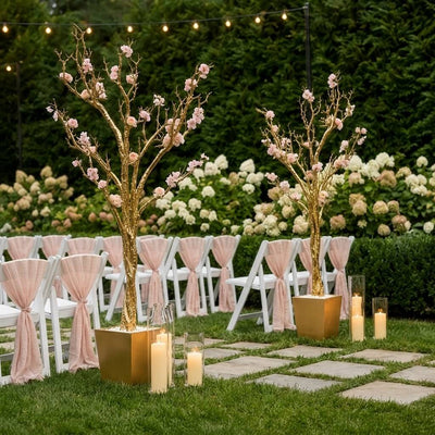 Two potted gold faux manzanita trees with pink flowers flanking outdoor seating - thumbnail number 4
