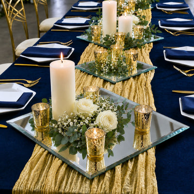 Candles, roses, and gold votives on a mirrored tray atop a gold runner on a blue table - thumbnail number 6