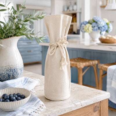 Canvas wine bottle gift bag with a drawstring tie on a kitchen counter - thumbnail number 6