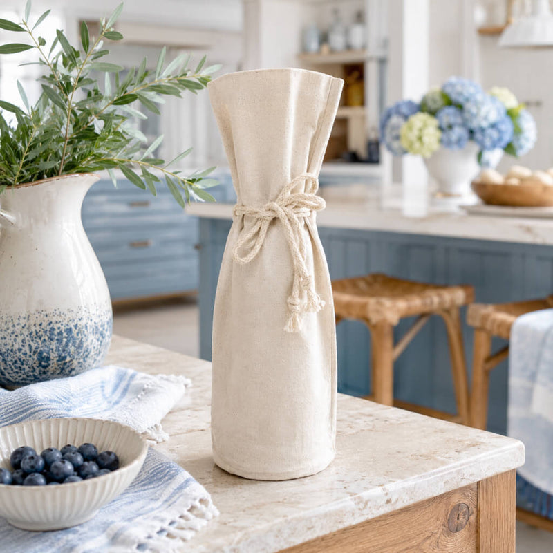 Canvas wine bottle gift bag with a drawstring tie on a kitchen counter - thumbnail number 6