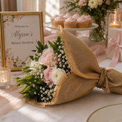 Bridal bouquet wrapped in a rustic burlap square next to a bridal shower sign - thumbnail number 6