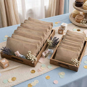 Zippered burlap bags displayed in wooden trays with floral accents on a party table - thumbnail number 2