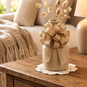 Natural burlap pull bow wrapped around the neck of a ceramic vase filled with dried stems - thumbnail number 11