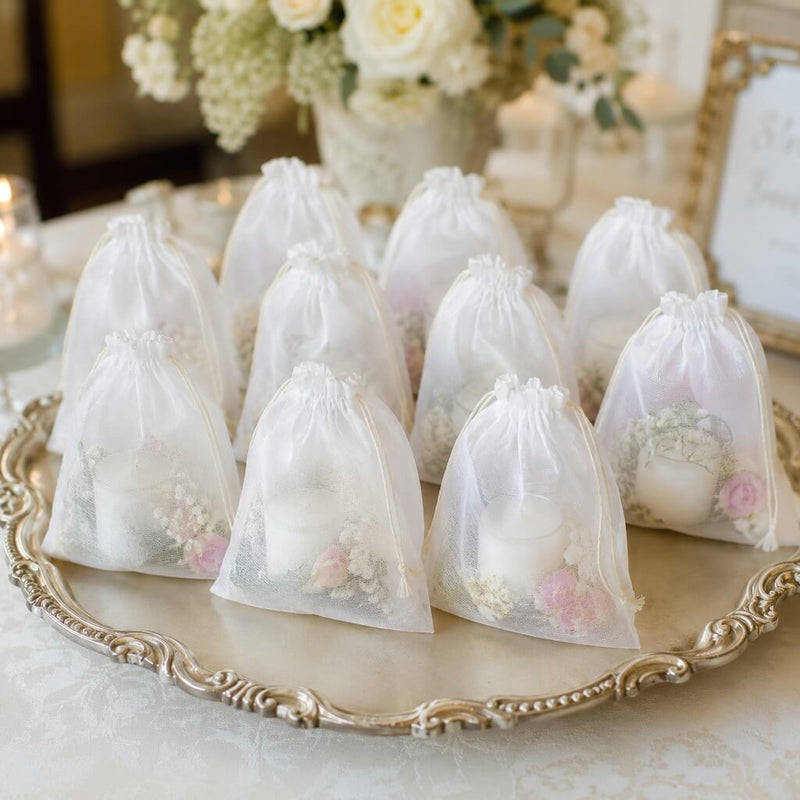 A pack of twelve 5x7in white muslin favor bags filled with candles and flowers on a silver tray - thumbnail number 4