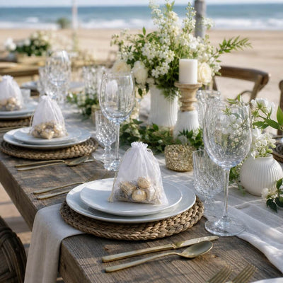 Beach wedding tablescape featuring white 5x7in muslin favor bags with treats on plates - thumbnail number 5