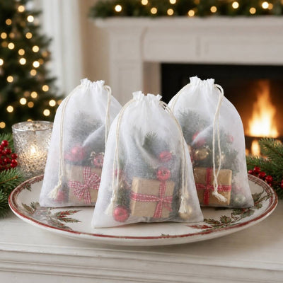 White 5x7in muslin favor bags filled with Christmas gifts and ornaments on a holiday table - thumbnail number 6