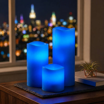Assorted blue LED pillar candles glowing in cozy nighttime setting - thumbnail number 12